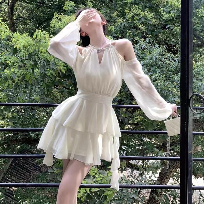 Apricotcolored Longsleeved Dress With A Cinched Waist Slimming Effect And Ethereal Ruffled Hem